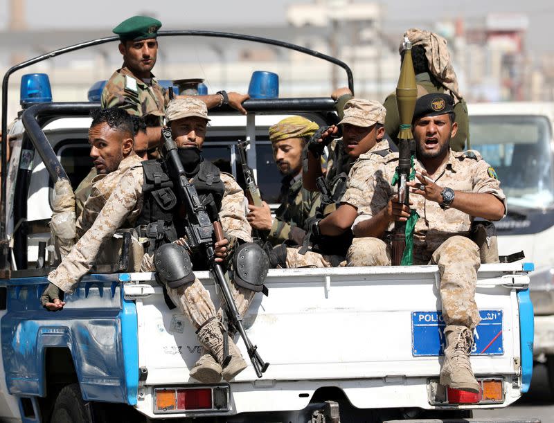 FILE PHOTO: Houthi troops ride on the back of a police patrol truck after participating in a Houthi gathering in Sanaa