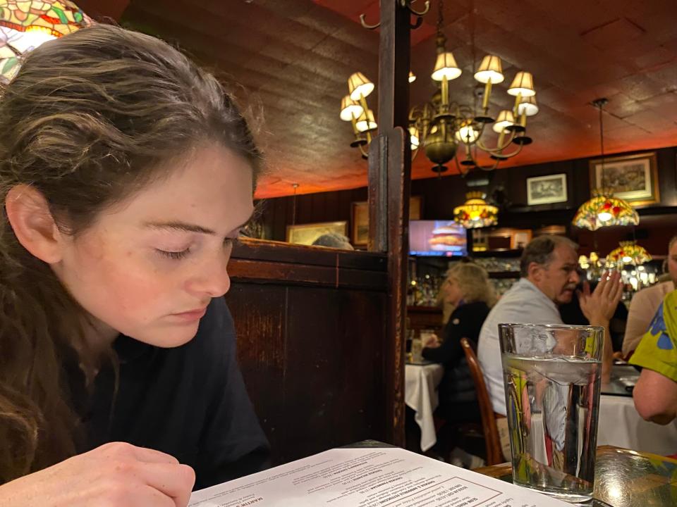 Woman reads menu in Martin's Tavern in DC.