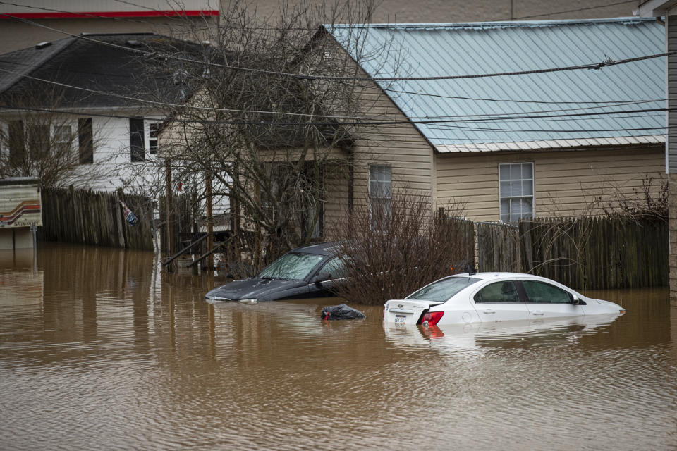 Flood water enters homes at the intersection of McGhee and Mason Street on Friday, Feb. 17, 2023, in Milton, W.Va. The flooding came amid a string of thunderstorms that inundated the South and dumped nearly 3 inches (8 centimeters) of rain in parts of West Virginia. (Sholten Singer/The Herald-Dispatch via AP)