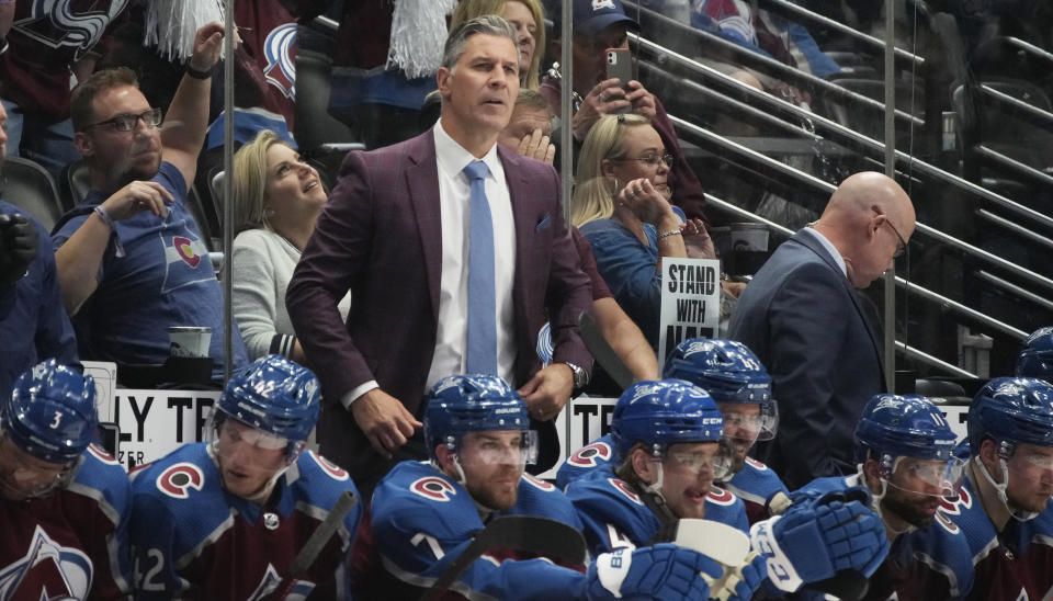 Colorado Avalanche coach Jared Bednar stands behind players on the bench during the second period of Game 5 of an NHL hockey Stanley Cup second-round playoff series against the St. Louis Blues on Wednesday, May 25, 2022, in Denver. (AP Photo/David Zalubowski)
