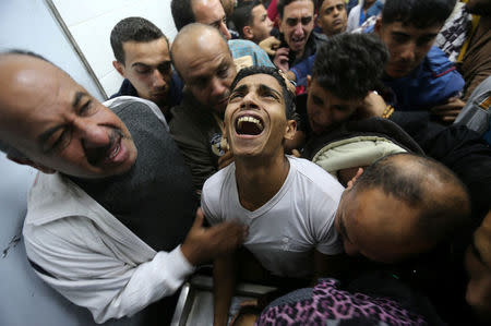 A relative of Palestinian Mohammed Abu Saada, who was killed on Friday during clashes with the Israeli troops near the Gaza-Israel border, mourns at a hospital morgue in the central Gaza Strip November 18, 2016. REUTERS/Ibraheem Abu Mustafa