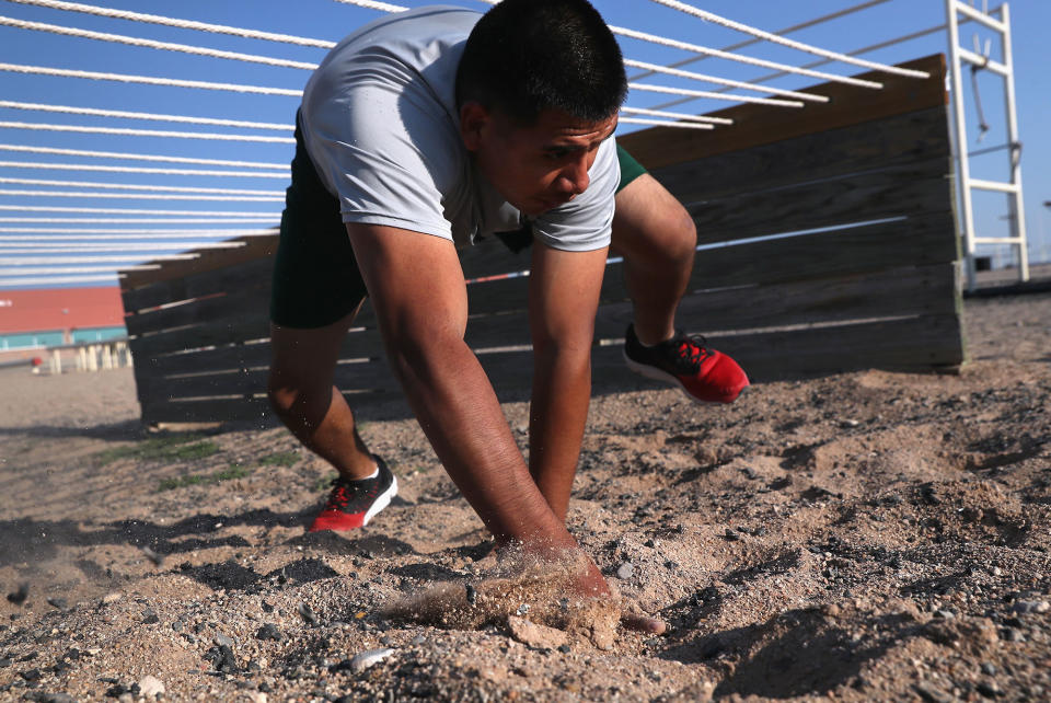 A trainee runs an obstacle course