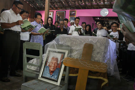 Family and friends pray beside the casket of Sodimejo, locally known as Mbah Gotho, who claimed to be the world's oldest person at 146-years-old, in Sambungmacan village, Sragen, Central Java, Indonesia May 1, 2017 in this photo taken by Antara Foto. Antara Foto/Mohammad Ayudha/via REUTERS