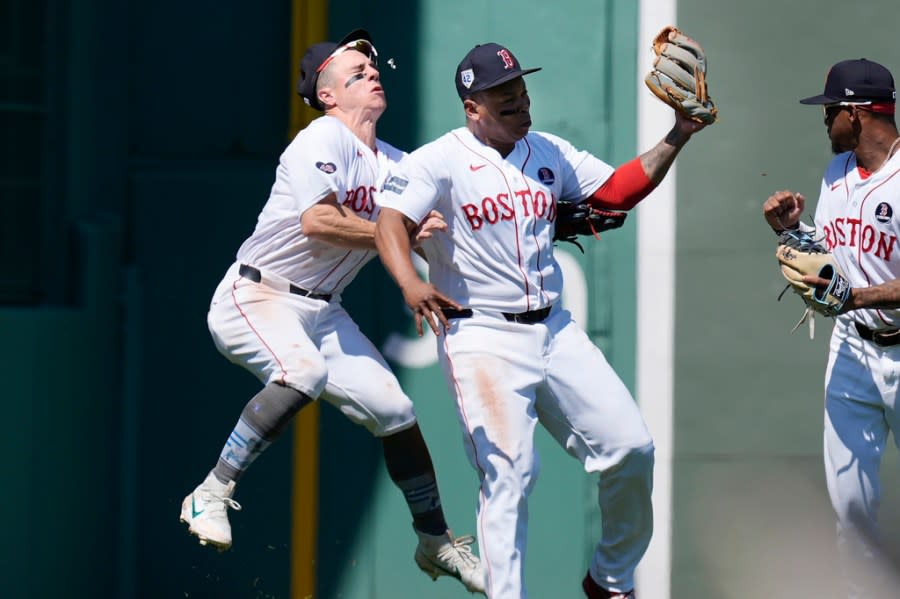 Boston Red Sox’s Rafael Devers, center, collides with teammate Tyler O’Neil after making the catch on a pop out by Cleveland Guardians’ <a class="link " href="https://sports.yahoo.com/mlb/players/10924/" data-i13n="sec:content-canvas;subsec:anchor_text;elm:context_link" data-ylk="slk:Estevan Florial;sec:content-canvas;subsec:anchor_text;elm:context_link;itc:0">Estevan Florial</a> as <a class="link " href="https://sports.yahoo.com/mlb/players/12730/" data-i13n="sec:content-canvas;subsec:anchor_text;elm:context_link" data-ylk="slk:Ceddanne Rafaela;sec:content-canvas;subsec:anchor_text;elm:context_link;itc:0">Ceddanne Rafaela</a>, right, looks on during the seventh inning of a baseball game, Monday, April 15, 2024, in Boston. (AP Photo/Michael Dwyer)