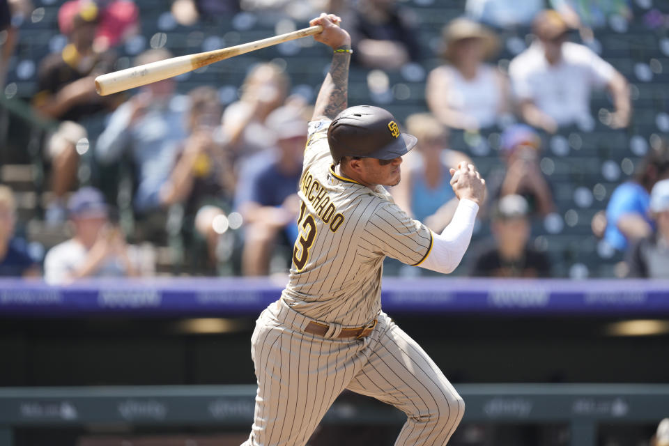 San Diego Padres' Manny Machado follows the flight of his RBI-single off Colorado Rockies starting pitcher Chi Chi Gonzalez in the third inning of a baseball game Wednesday, Aug. 18, 2021, in Denver. (AP Photo/David Zalubowski)