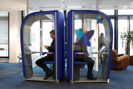 Employees work on computers in silence phone boxes at the French start-up Sigfox offices in Paris, France, February 14, 2018. REUTERS/Benoit Tessier