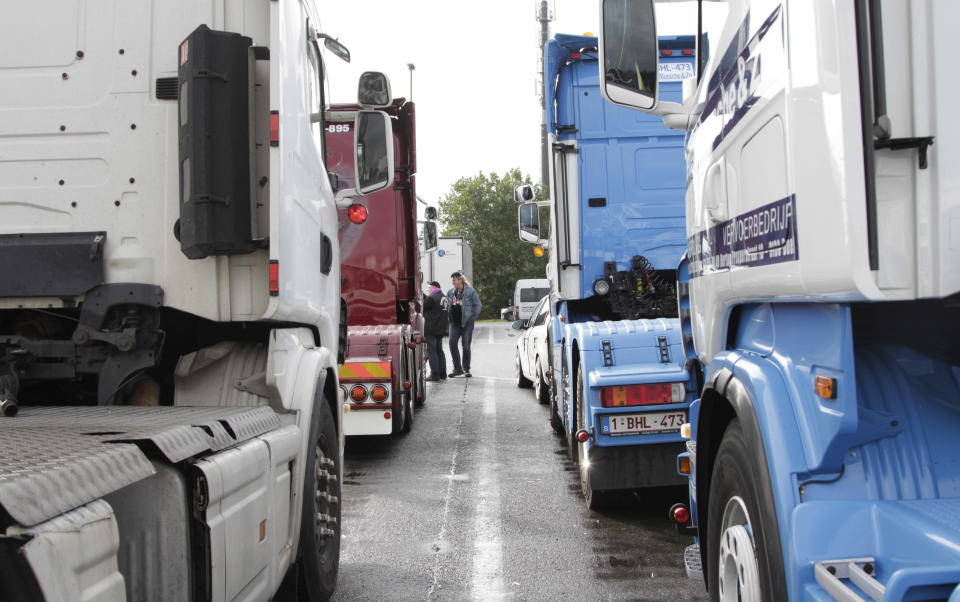 Truckers gather to perform a 'drive slow' action to Brussels at a tank station in Waarloos, Belgium on Monday, Sept. 24, 2012. Truckers will seek to disrupt morning traffic heading into the capital to protest competition from eastern Europe, which undercuts prices and lowers labor standards. (AP Photo/Virginia Mayo)