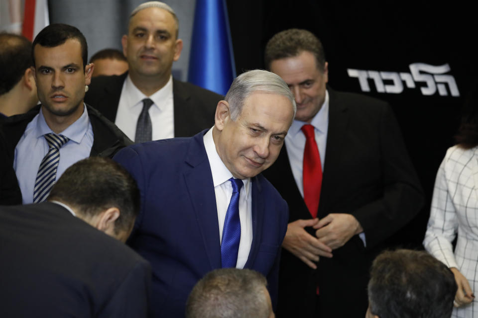 Israeli Prime Minister Benjamin Netanyahu arrives to deliver a statement at the airport city in Lod Israel, Friday, Dec. 27, 2019. Netanyahu shored up his base with a landslide primary victory announced early Friday, but he will need a big win in national elections in March if he hopes to stay in office and gain immunity from prosecution on corruption charges. (AP Photo/Ariel Schalit)