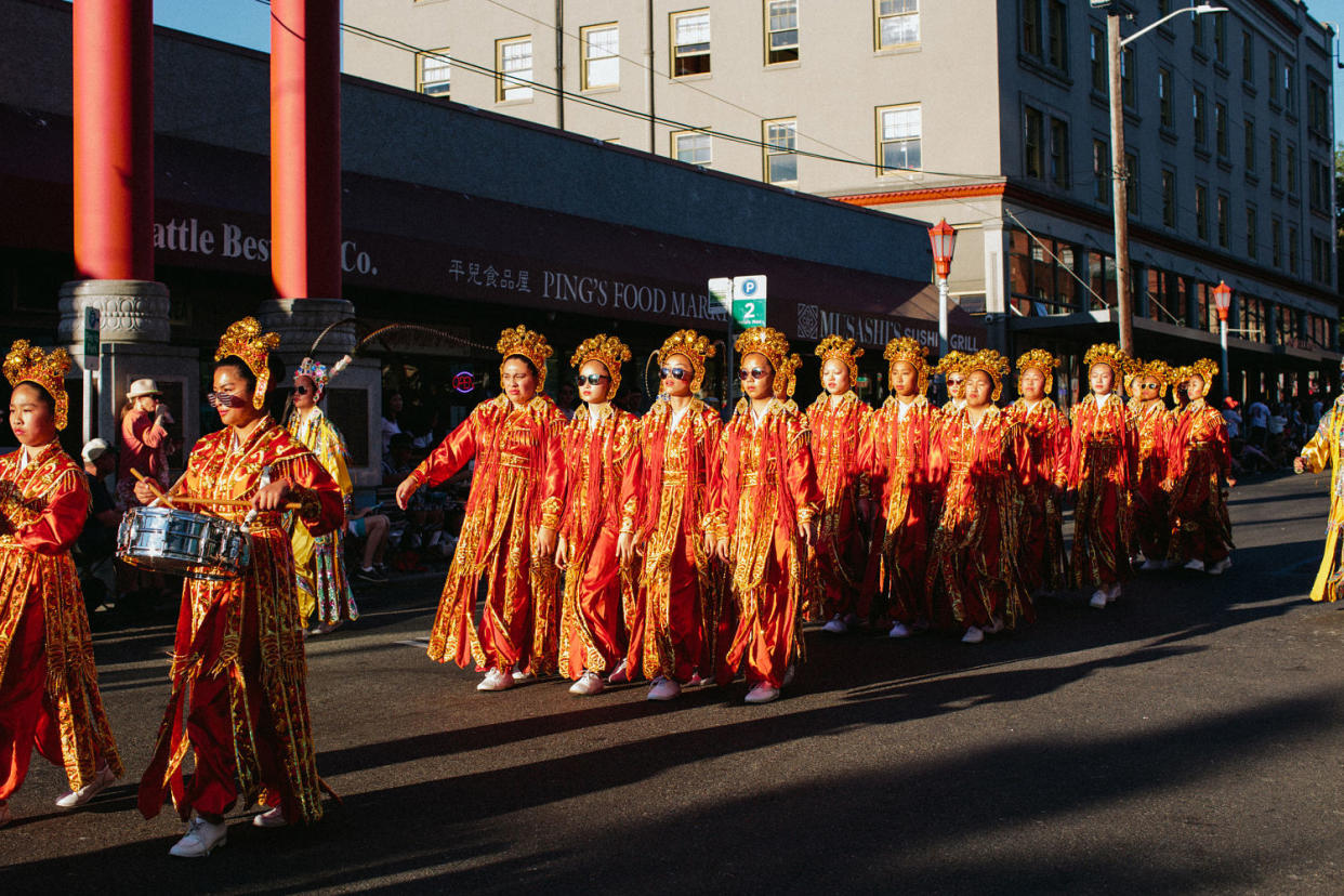 Drill Team members in high school wear sunglasses during the Chinatown Seafair Parade in 2017. (via Chenanigan Films)