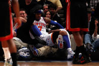 NEW YORK, NY - MAY 06: Carmelo Anthony #7 of the New York Knicks falls into a row of photographers in the first quarter against the New York Knicks in Game Four of the Eastern Conference Quarterfinals in the 2012 NBA Playoffs on May 6, 2012 at Madison Square Garden in New York City. NOTE TO USER: User expressly acknowledges and agrees that, by downloading and or using this photograph, User is consenting to the terms and conditions of the Getty Images License Agreement (Photo by Jeff Zelevansky/Getty Images)