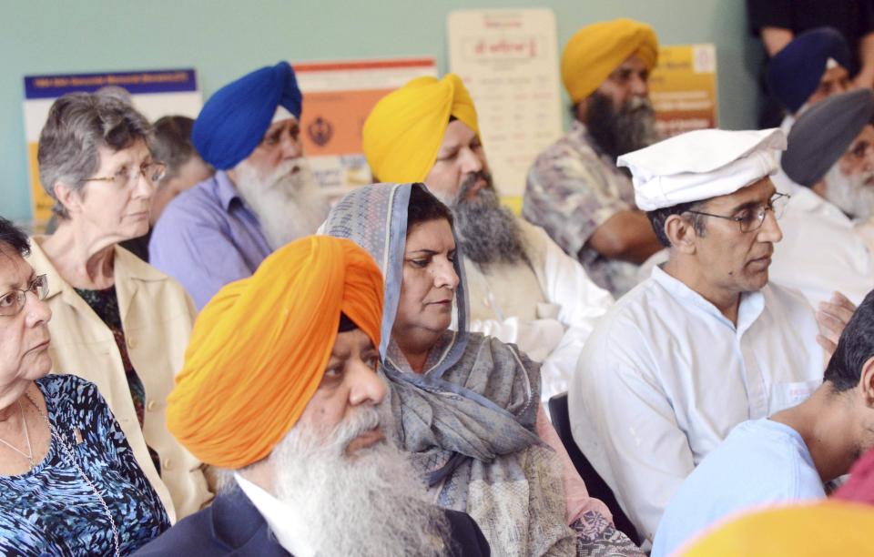 In this June 1, 2019 photo, people listen to speakers during Sikh Memorial Day marking the 1984 Sikh genocide, at the Otis Library in Norwich, Conn., where a 1984 Sikh Genocide Memorial plaque was installed. The library has removed the memorial to Sikhs killed in India 35 years ago after a protest call from the Indian Consulate in New York. (John Shishmanian/NorwichBulletin.com via AP)