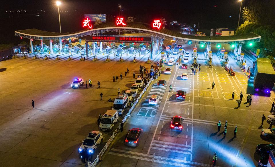 This aerial photo taken early on April 8, 2020 shows cars queueing at a highway toll station in Wuhan in China's central Hubei province, as they prepare to leave the city after authorities lifted a more than two-month ban on outbound travel. - Thousands of Chinese travellers rushed to leave COVID-19 coronavirus-ravaged Wuhan early on April 8 as authorities lifted a more than two-month prohibition on outbound travel from the city where the global pandemic first emerged. (Photo by STR / AFP) / China OUT (Photo by STR/AFP via Getty Images)