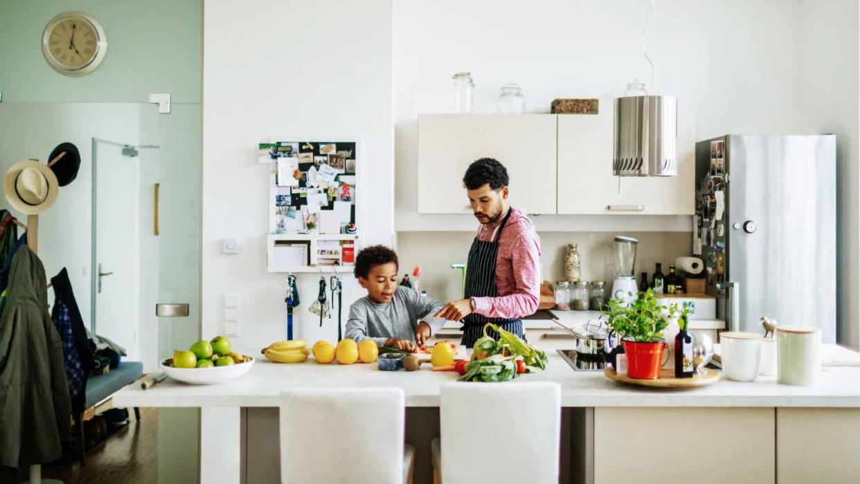 Father and son helping cooking