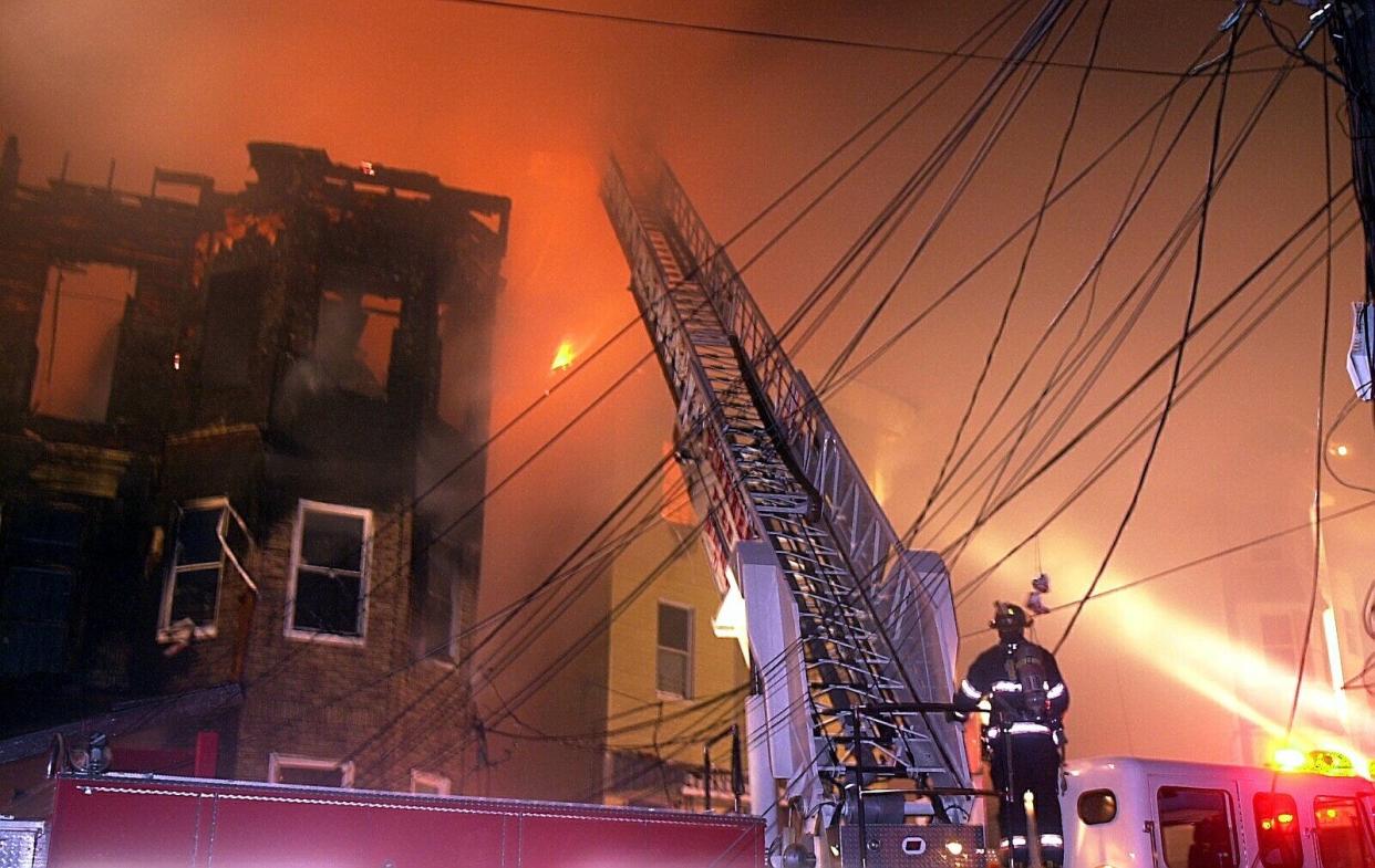 Overhead utility wires melted and fell as Yonkers firefighters fought the Oak Street fire on March 14, 2003.