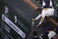 A beekeeper sprays a bee during an interruption in play in a quarterfinal match between Carlos Alcaraz, of Spain, and Alexander Zverev, of Germany, at the BNP Paribas Open tennis tournament, Thursday, March 14, 2024, in Indian Wells, Calif. (AP Photo/Mark J. Terrill)