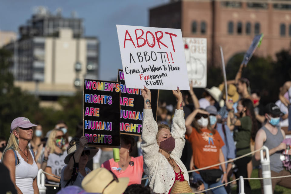 FILE - People attend the Women's March ATX rally, Saturday, Oct., 2, 2021, at the Texas State Capitol in Austin, Texas. An expected decision by the U.S. Supreme Court in the coming year to severely restrict abortion rights or overturn Roe v. Wade entirely is setting off a renewed round of abortion battles in state legislatures. (AP Photo/Stephen Spillman, File)