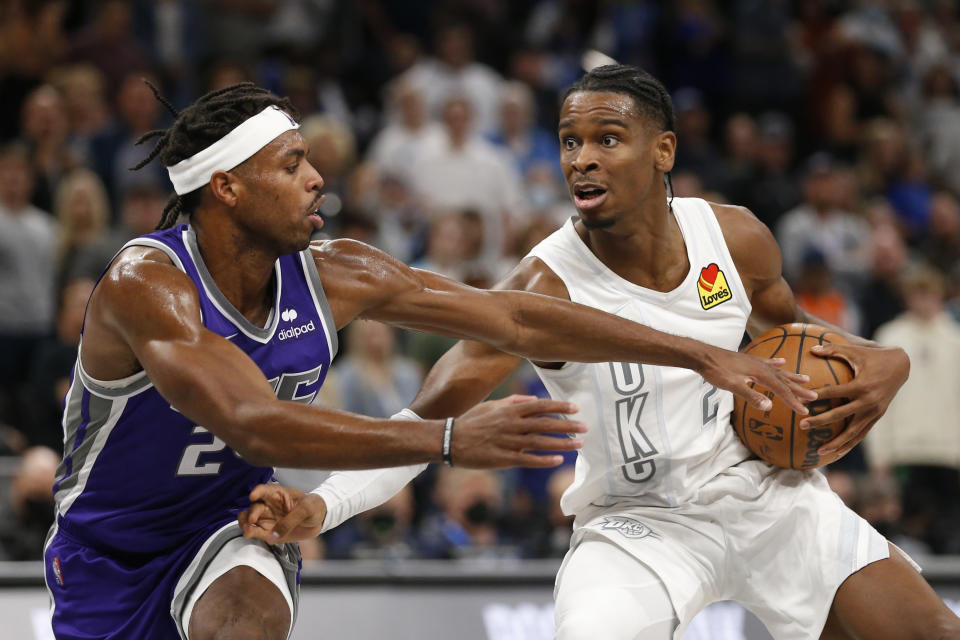 Oklahoma City Thunder guard Shai Gilgeous-Alexander (2) goes against Sacramento Kings guard Buddy Hield (24) during the second half of an NBA basketball game, Friday, Nov. 12, 2021, in Oklahoma City. (AP Photo/Garett Fisbeck)