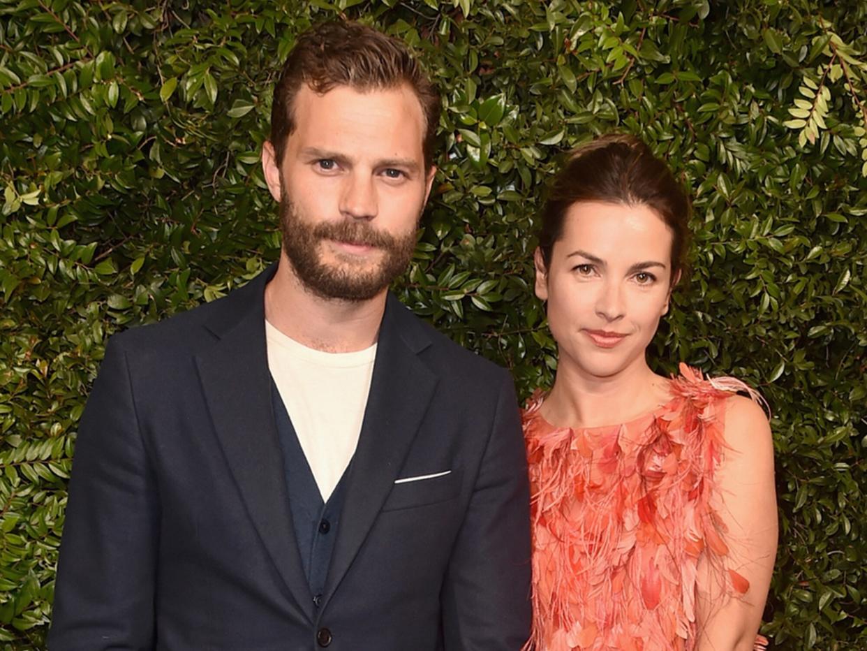 Jamie Dornan (L) and Amelia Warner attend Charles Finch and Chanel Pre-Oscar Awards Dinner at Madeo in Beverly Hills on March 3, 2018 in Beverly Hills, California