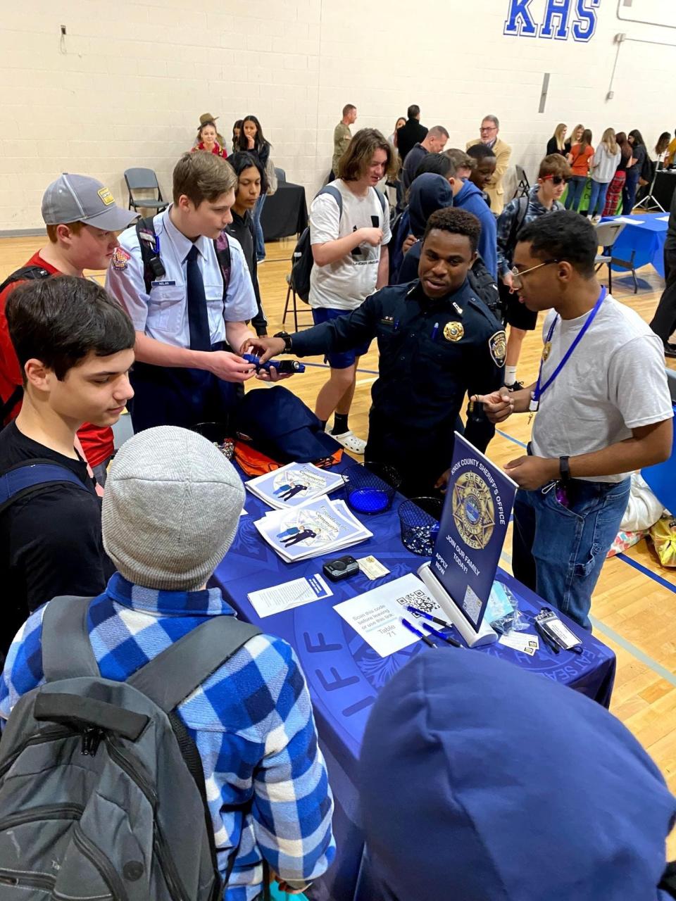 Army National Guard Specialist, KCSO Corrections officer and Karns High alum Leo Piety tells students Kyle Lefevre, Jackson Gerdes, Preston Nolan and Adrien Foster about the world of law enforcement at a Career Pathways Fair Jan. 26 at Karns High School.