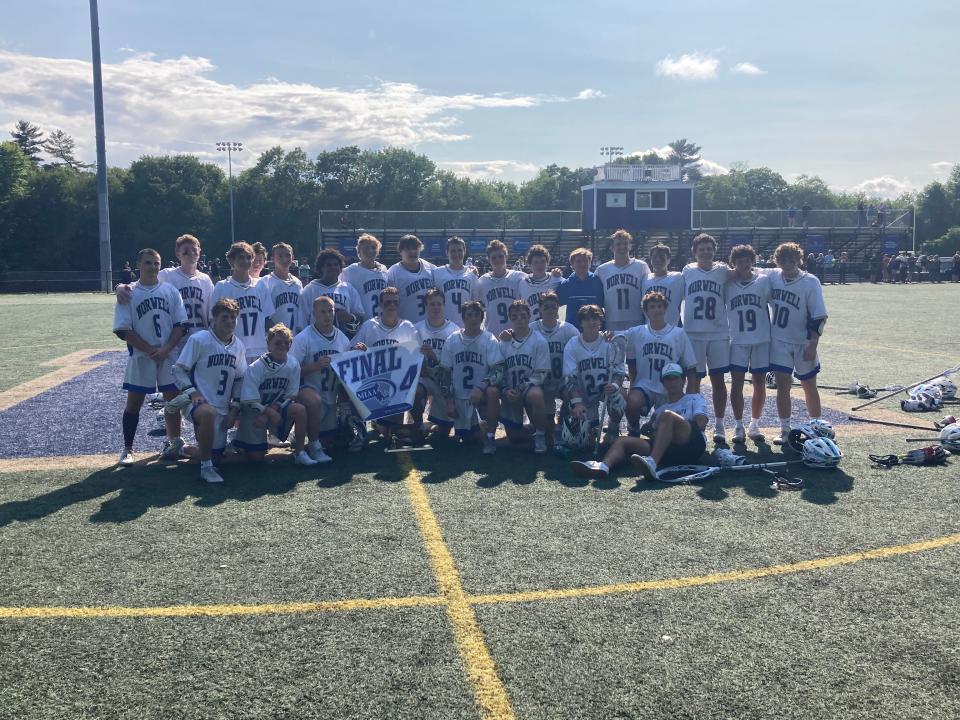 Members of the Norwell High boys lacrosse team pose with the Division 3 Final Four banner and trophy after beating Pope Francis, 12-6, in a state quarterfinal game at Norwell on Saturday, June 10, 2023.