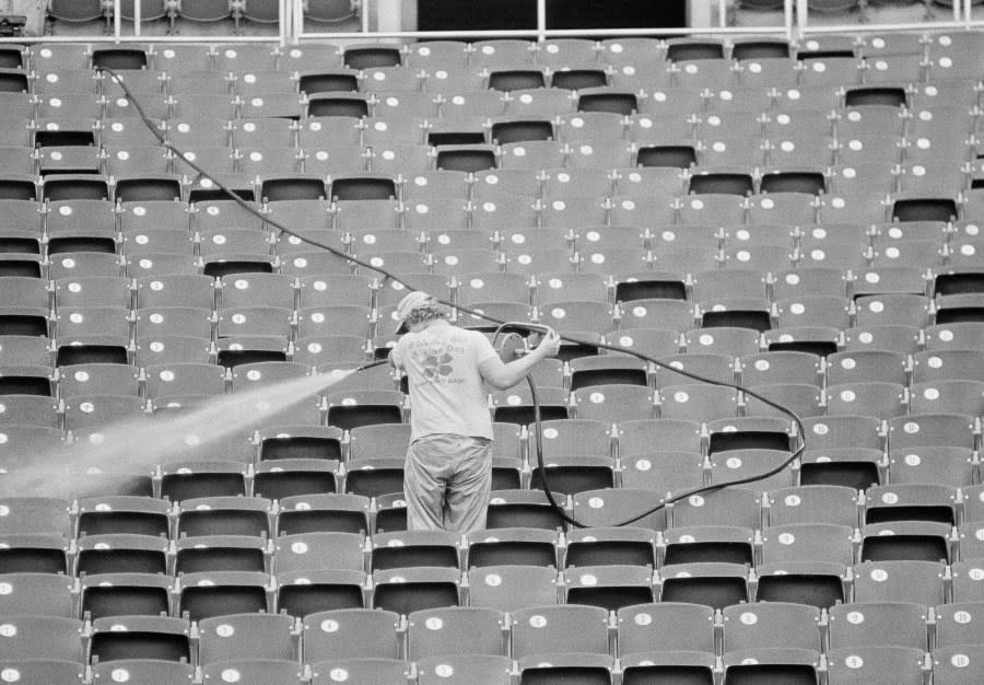 A Veteran Stadium employed uses a high pressure washer to clean seats in the stands in preparation for Fridays National League playoff game against the Los Angeles Dodgers, Oct. 7, 1977, Philadelphia, Pa. (AP Photo)