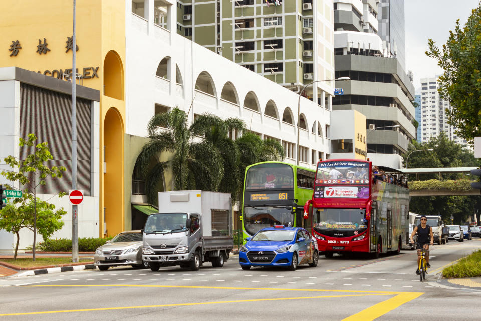 Traffic transportation stopped at red light on a street in Singapore, illustrating a story on the latest COE prices.