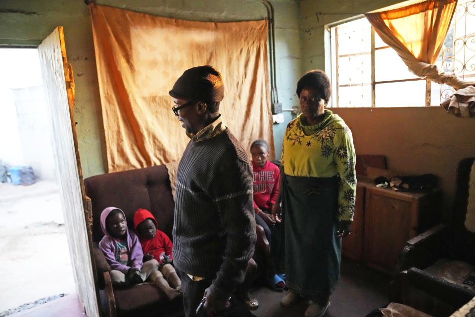 Jeffrey Carlos, left, and his wife Christwish are seen inside their house on the outskirts of Harare on Wednesday, Aug, 3, 2022. Carlos, a father of three, says he gets about $100 dollars a month from his job as an overnight security guard for a church and the bar next door. Rising prices and a fast-depreciating currency have pushed many Zimbabweans to the brink, reminding people of when the southern African country faced world-record inflation of 5 billion % in 2008.(AP Photo/Tsvangirayi Mukwazhi)