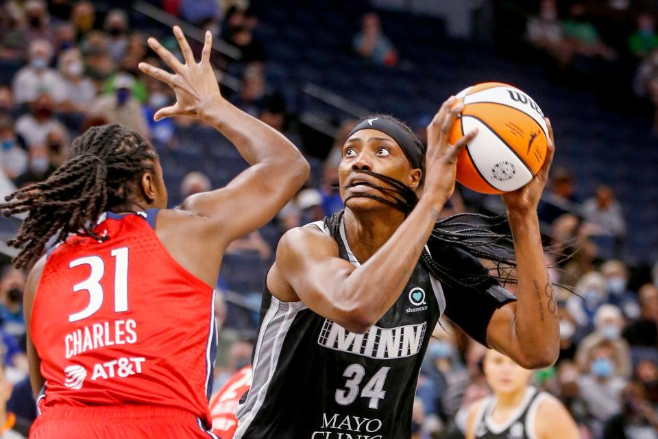 Minnesota Lynx center Sylvia Fowles (34) shoots over center Tina Charles during a Sept. 4, 2021 game.