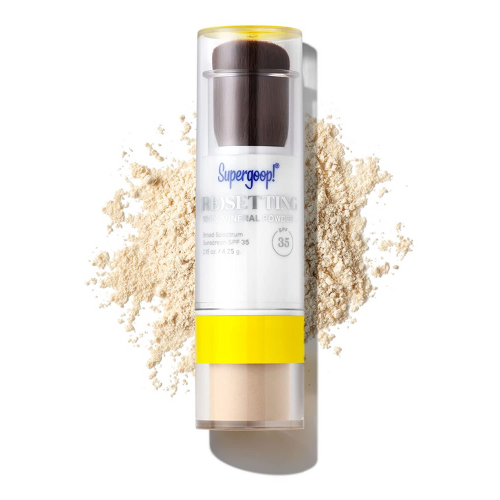 Supergoop! mineral powder spf laying on brown powder