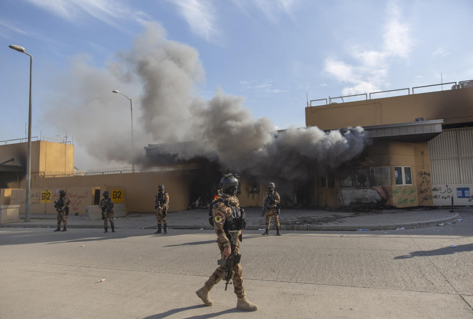 Iraqi army soldiers are deployed in front of the U.S. embassy, in Baghdad, Iraq, Wednesday, Jan. 1, 2020. Iran-backed militiamen have withdrawn from the U.S. Embassy compound in Baghdad after two days of clashes with American security forces. (AP Photo/Nasser Nasser)