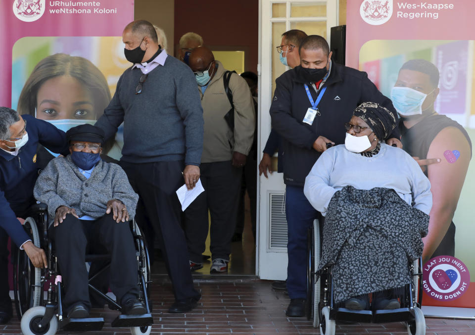 FILE - In this May 17, 2021, file photo, Anglican Archbishop Emeritus, Desmond Tutu, left, and his wife Leah leave, after receiving shots of the COVID-19 vaccine, at the Brooklyn Chest Hospital in Cape Town, South Africa. New infections in South Africa rose to record levels in recent days, part of a rapid rise across the continent, and experts say the surge here has not yet peaked. South Africa reimposed several restrictions, and its vaccination drive is finding its feet after several stumbles. But even as the campaign gathers pace, experts say it's too late to reduce the deadly impact of the current spike. (AP Photo/Nardus Engelbrecht, File)