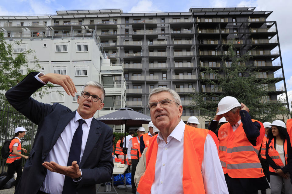 International Olympic Committee (IOC) president Thomas Bach, center, visits the Athletes' village in Saint-Ouen-sur-Seine, outside Paris, Tuesday, July 25, 2023. (Pascal Rossignol/Pool via AP)