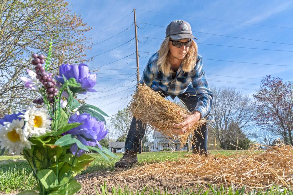 Johnny Thornton Jr. works on a burial plot Thursday, April 18, 2024 at West Ridge Park Cemetery. He is responsible for the cemetery grounds and this day, he puts topsoil, grass seed and straw on newer plots.