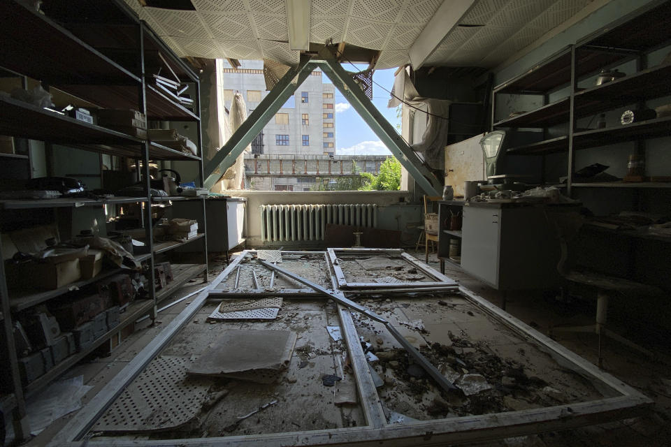 A broken window lies on the floor inside the department which was damaged after Russian attack at National Scientific Center "Kharkov Institute of Physics and Technology" in Kharkiv, Ukraine, Thursday, May 18, 2023. The U.S. government says the Kharkiv nuclear facility, built in collaboration with the Argonne National Laboratory near Chicago, is the first of its kind in the world, "designed to produce medical isotopes, train nuclear professionals, support the Ukrainian nuclear industry, and provide experimental capabilities for performing reactor physics, materials, and basic science research." (AP Photo/Oleksandr Brynza)