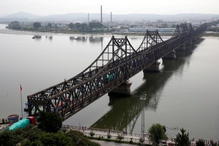 Trucks cross Friendship Bridge from China's Dandong, Liaoning province, to North Korea's Sinuiju September 12, 2016. REUTERS/Thomas Peter/File Photo