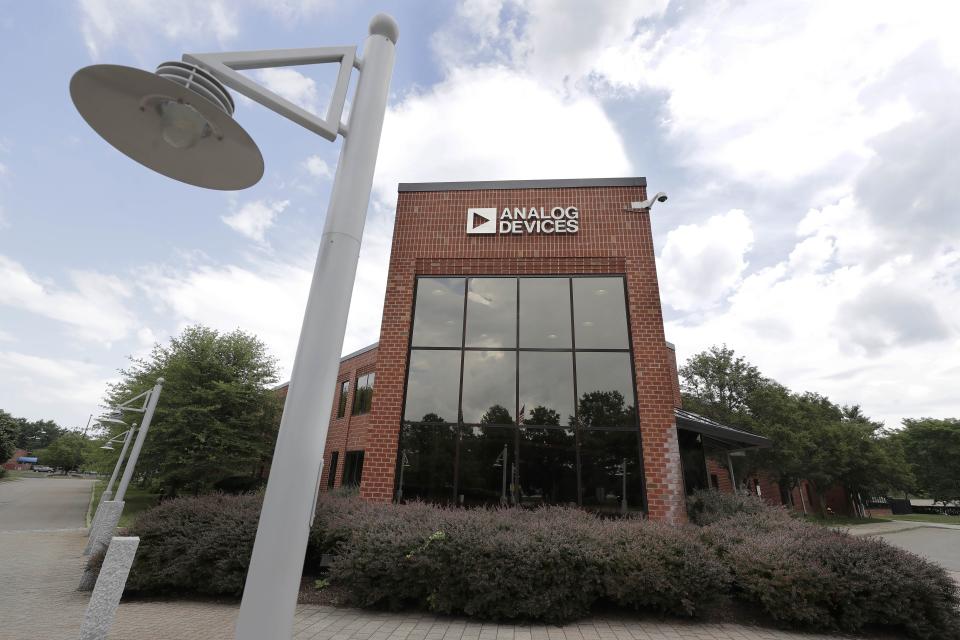 Clouds are reflected in the headquarters of Analog Devices, Inc., Monday, July 13, 2020, in Norwood, Mass. Computer chip maker Analog Devices is buying Maxim Integrated in an all-stock deal that will create a company worth about $68 billion, and strengthens its position in the analog semiconductor sector. (AP Photo/Steven Senne)