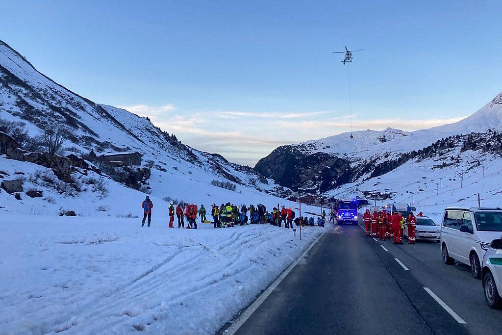 Photo made available by Lech Zuers Tourismus shows members of the emergency services working near the scene of an avalanche at Bregenz, Austria on December 25, 2022