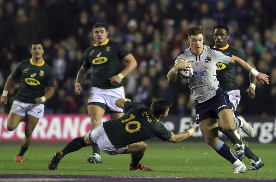 Scotland's Huw Jones, right, avoids a tackle from South Africa's Handre Pollard, left, during the rugby union international match between Scotland and South Africa at Murrayfield stadium, in Edinburgh, Scotland, Saturday, Nov. 17, 2018. (AP Photo/Scott Heppell)