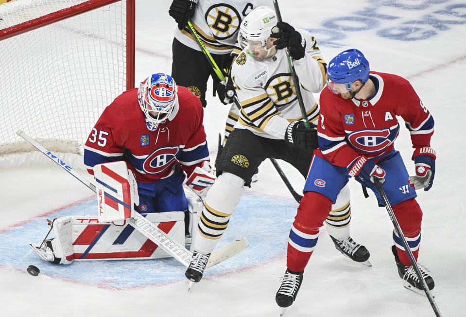 Montreal Canadiens goaltender Sam Montembeault (35) stops Boston Bruins' James van Riemsdyk (21) as Canadiens' Mike Matheson (8) defends during second-period NHL hockey game action in Montreal, Saturday, Nov. 11, 2023. (Graham Hughes/The Canadian Press via AP)