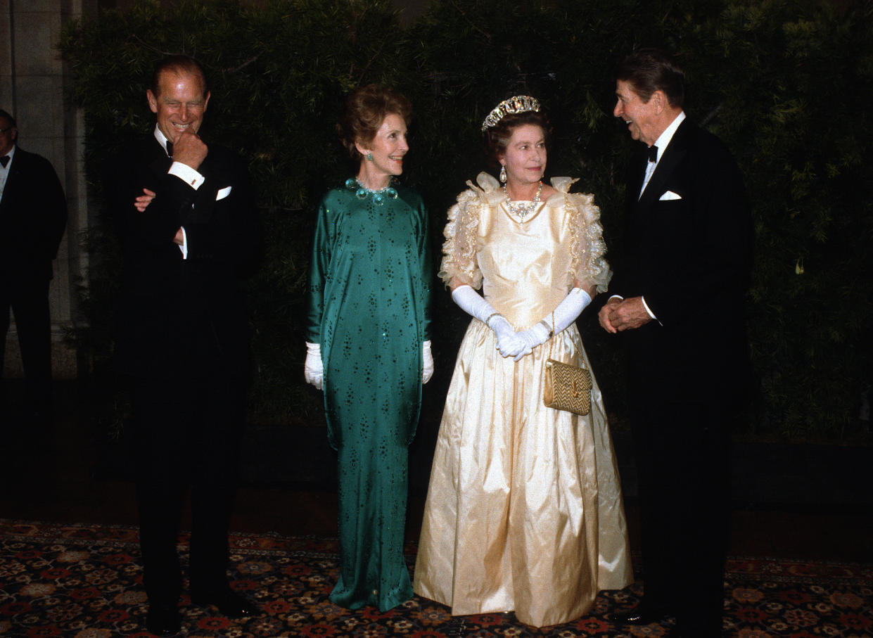 Prince Philip cracks up as Nancy Reagan, Queen Elizabeth ll and President Ronald Reagan converse.