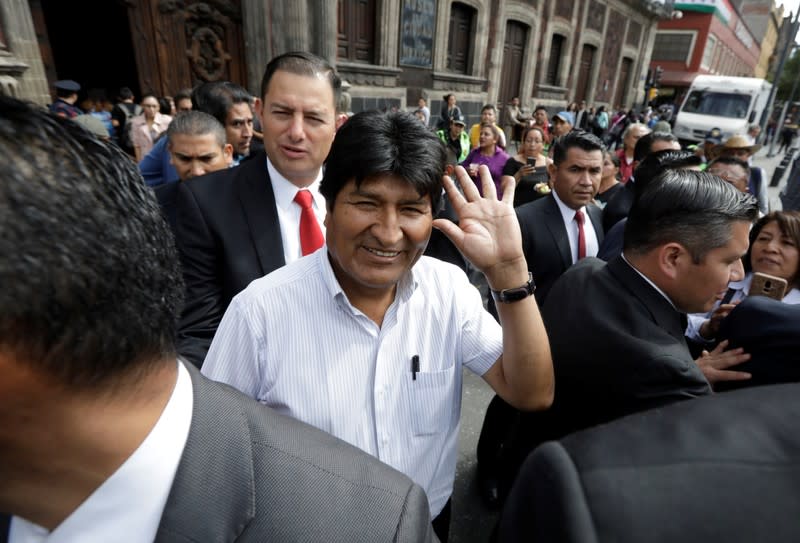 Bolivia's ousted president Evo Morales waves while heading to the town hall for a meeting with Mexico's City mayor Claudia Sheinbaum, in Mexico City