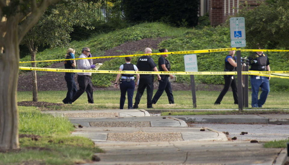 FILE - In this May 31, 2019 file photo, police work the scene where multiple people were killed during a mass shooting at the Virginia Beach city public works building in Virginia Beach, Va. A state commission tasked with investigating the 2019 mass shooting in Virginia Beach has called for numerous changes to how Virginia and its communities respond to mass shootings. (L. Todd Spencer/The Virginian-Pilot via AP, File)