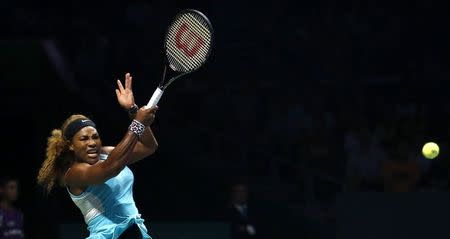 Serena Williams of the U.S. plays a shot against Ana Ivanovic of Serbia during their WTA Finals singles tennis match in Singapore October 20, 2014. REUTERS/Edgar Su