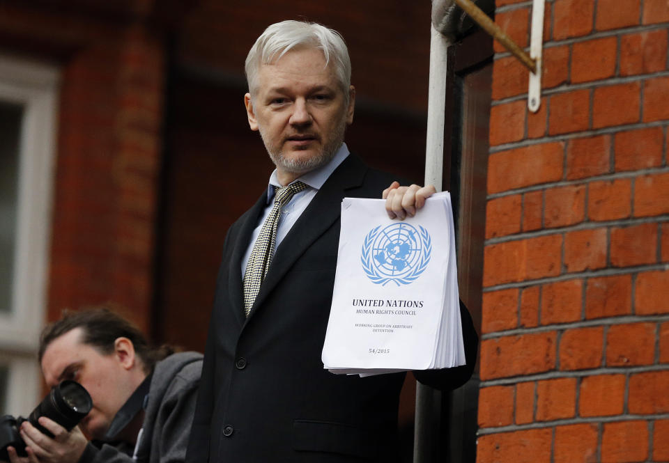 FILE - In this Friday, Feb. 5, 2016 file photo, WikiLeaks founder Julian Assange stands on the balcony of the Ecuadorean Embassy to address waiting supporters and media in London. Police in London arrested WikiLeaks founder Assange at the Ecuadorean embassy Thursday, April 11, 2019 for failing to surrender to the court in 2012, shortly after the South American nation revoked his asylum. (AP Photo/Frank Augstein, File)