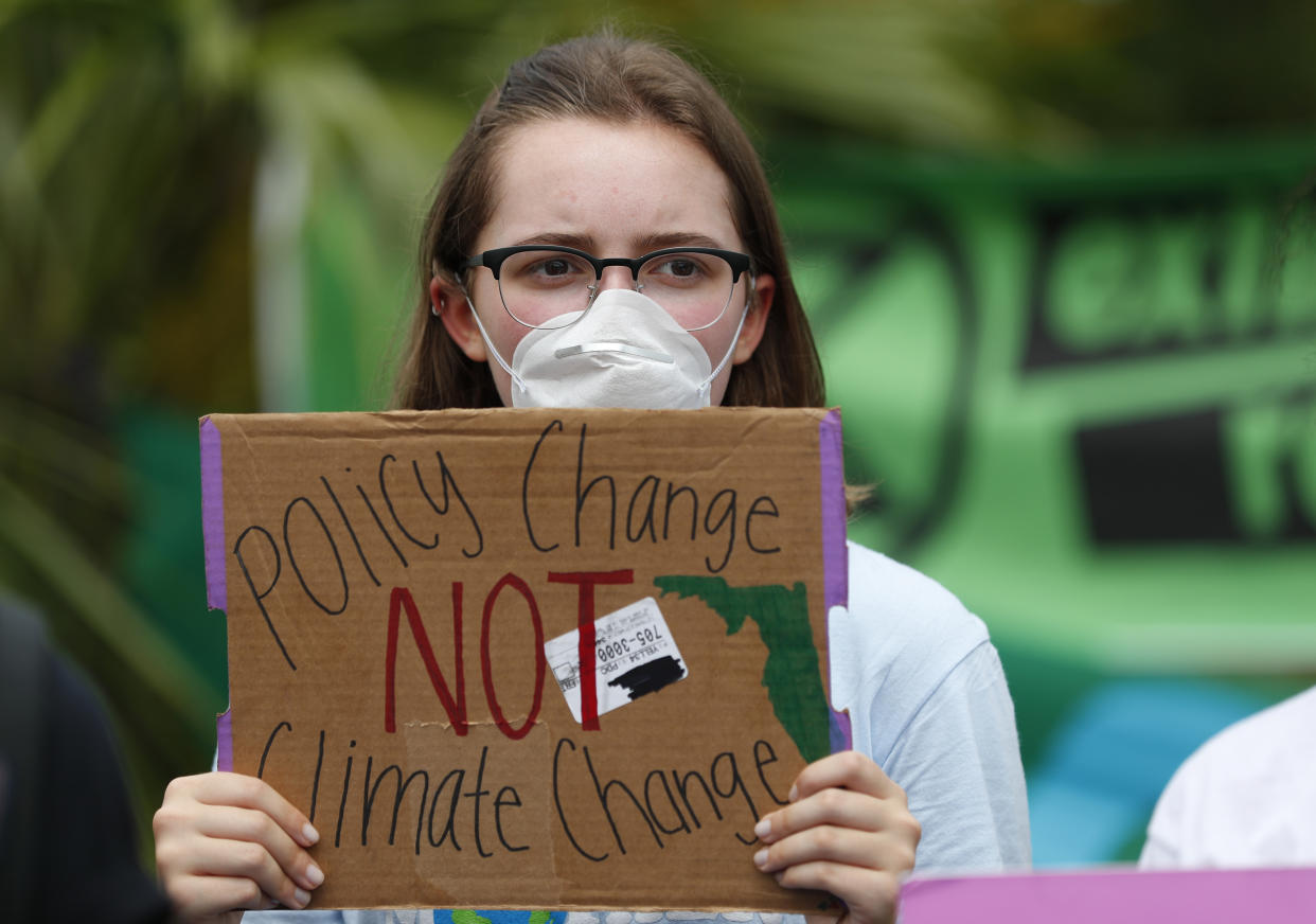 Ana Bermudez, 16, holds up a sign pleading for policy change during a demonstration. (Photo: Wilfredo Lee/AP)