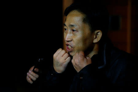 North Korean national Ri Jong Chol speaks to the media from behind the fence of the North Korean embassy compound in Beijing, China, March 4, 2017. REUTERS/Thomas Peter