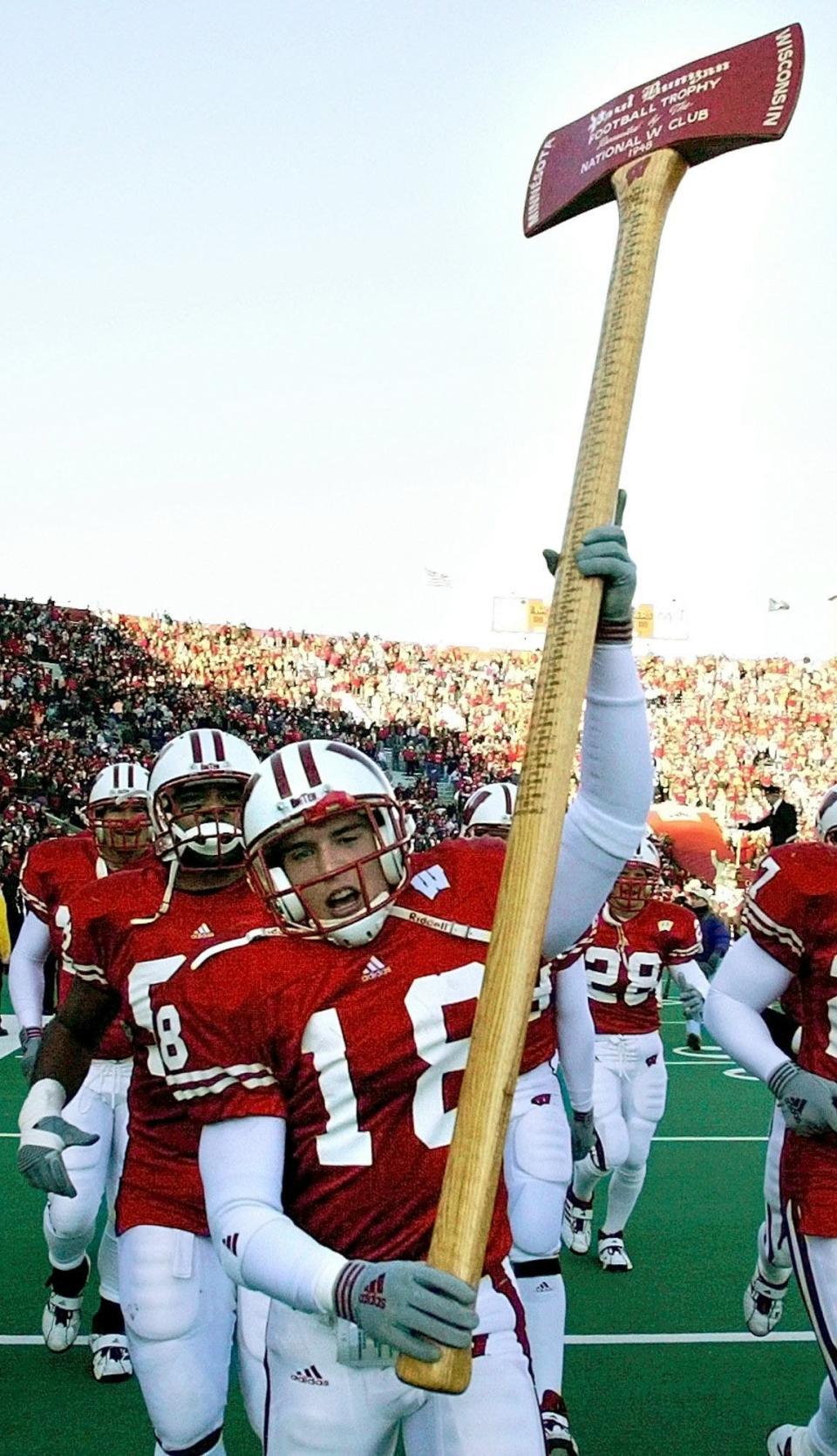 Wisconsin's Jim Leonhard holds up the Paul Bunyan Axe after the Badgers beat Minnesota, 49-31, in Madison on Nov. 23, 2002. Leonhard had two interceptions in the game.