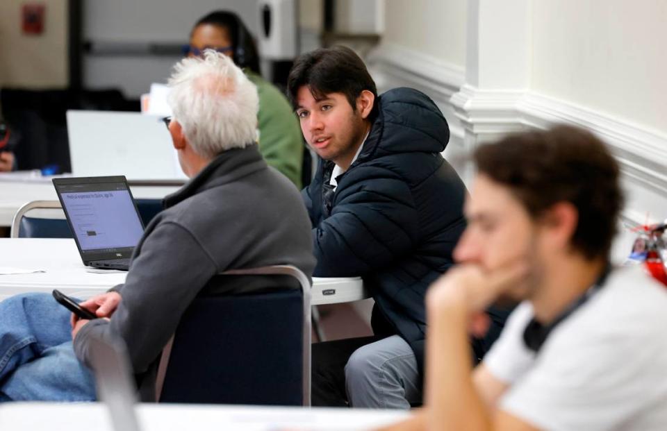 Kevin Ocampo, center right, helps a consumer with a Medicaid application during a Wake County ACA and Medicaid enrollment event at Martin Street Baptist Church in Raleigh, N.C., Friday, Dec. 1, 2023. Ethan Hyman/ehyman@newsobserver.com