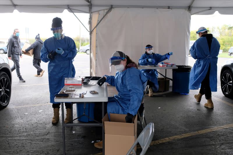 FILE PHOTO: FILE PHOTO: People line up to get COVID-19 tests in Milwaukee