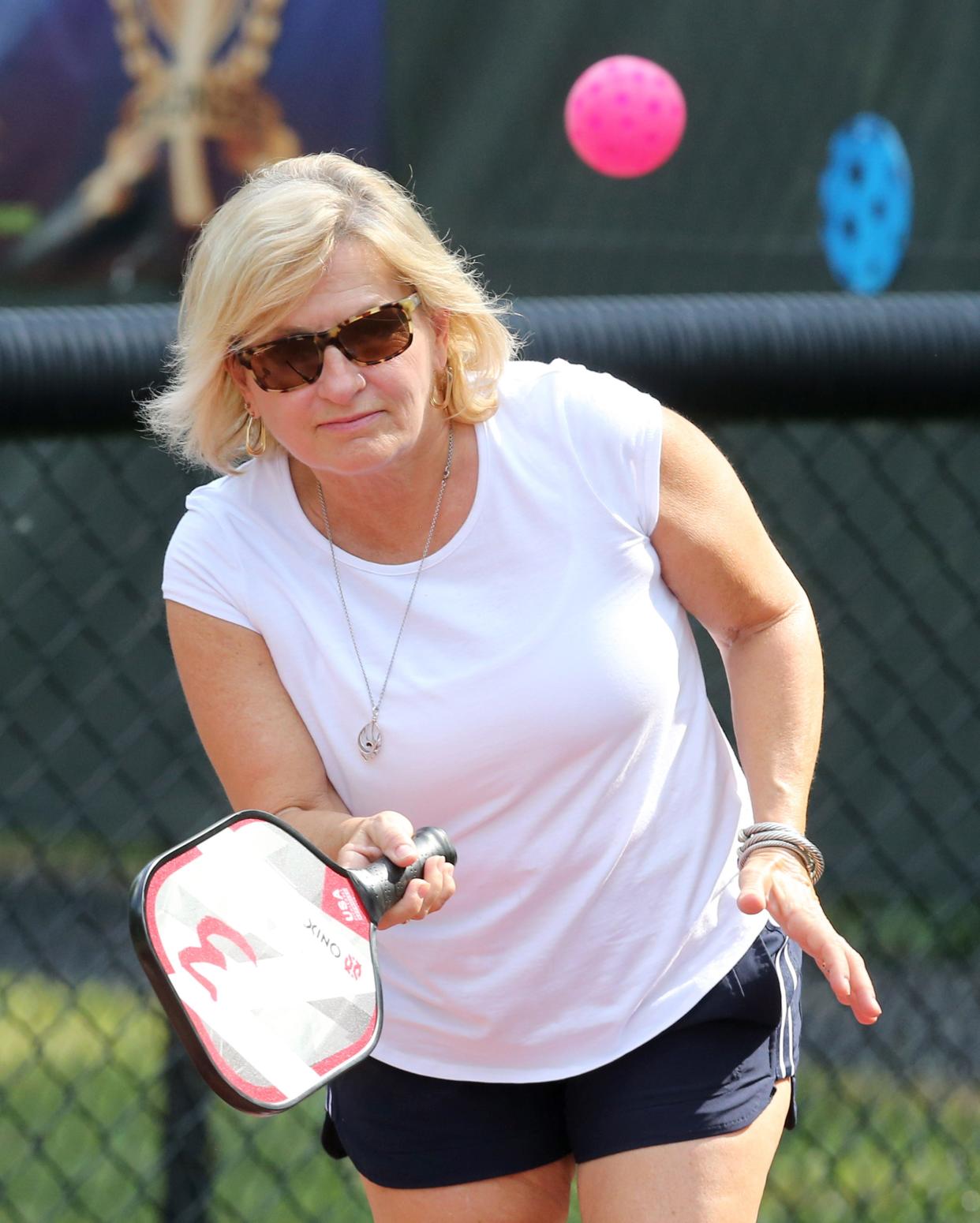 Jennie Parrish plays pickleball against her friend Harry "Hop" Delp at Stadium Park in Canton.